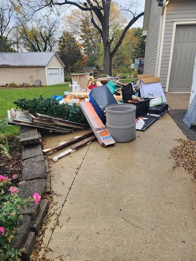 Dumpster being loaded with debris for Estate Cleanout Dumpster Rental in Waxahachie